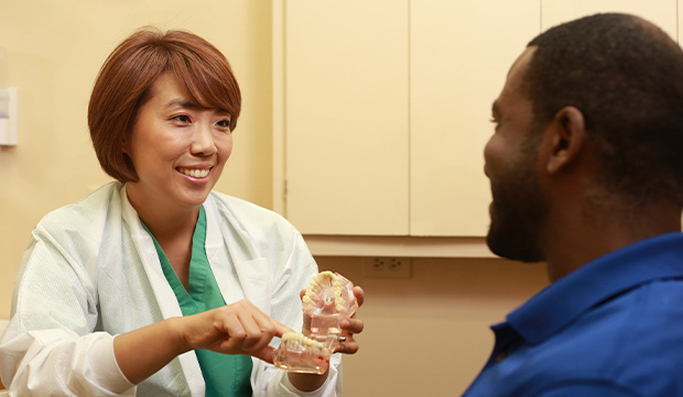 Dental team member smiling at patient