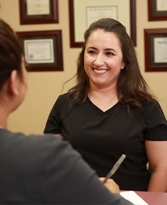 Team member smiling at dental patient