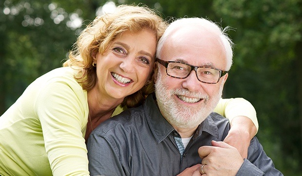 Smiling man and woman outdoors