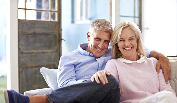 elderly couple sitting on a couch