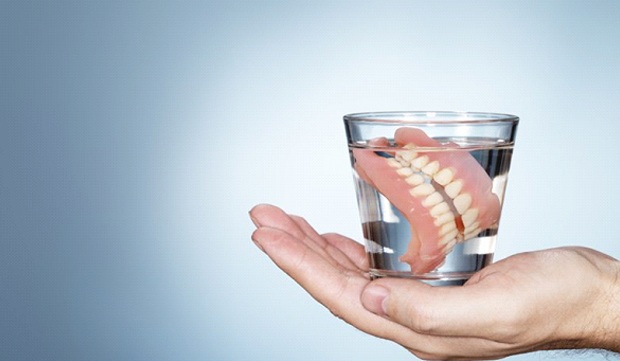 full dentures in glass of water