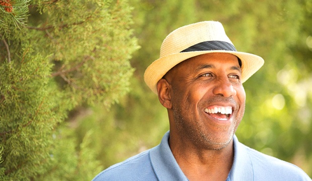 man standing in front of trees