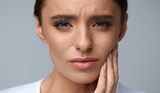 Woman holding jaw