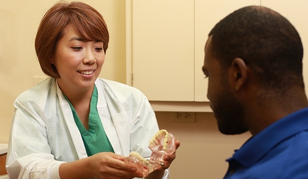 Dr. Kim talking to dental patient