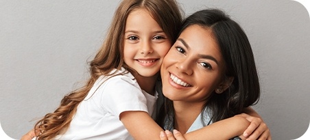 Mother and daughter smiling