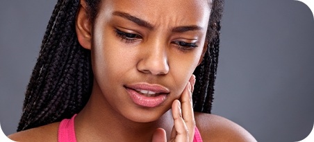 Woman holding jaw