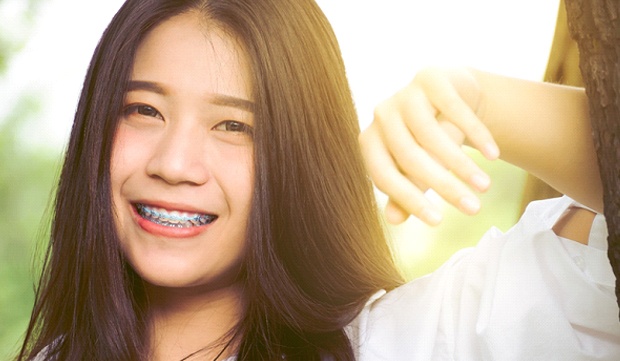 A young girl smiling with braces