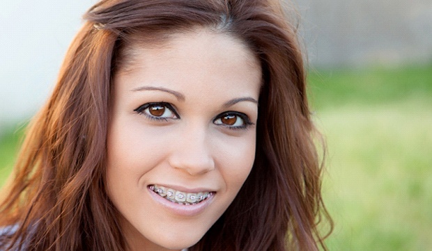 A young girl smiling with braces